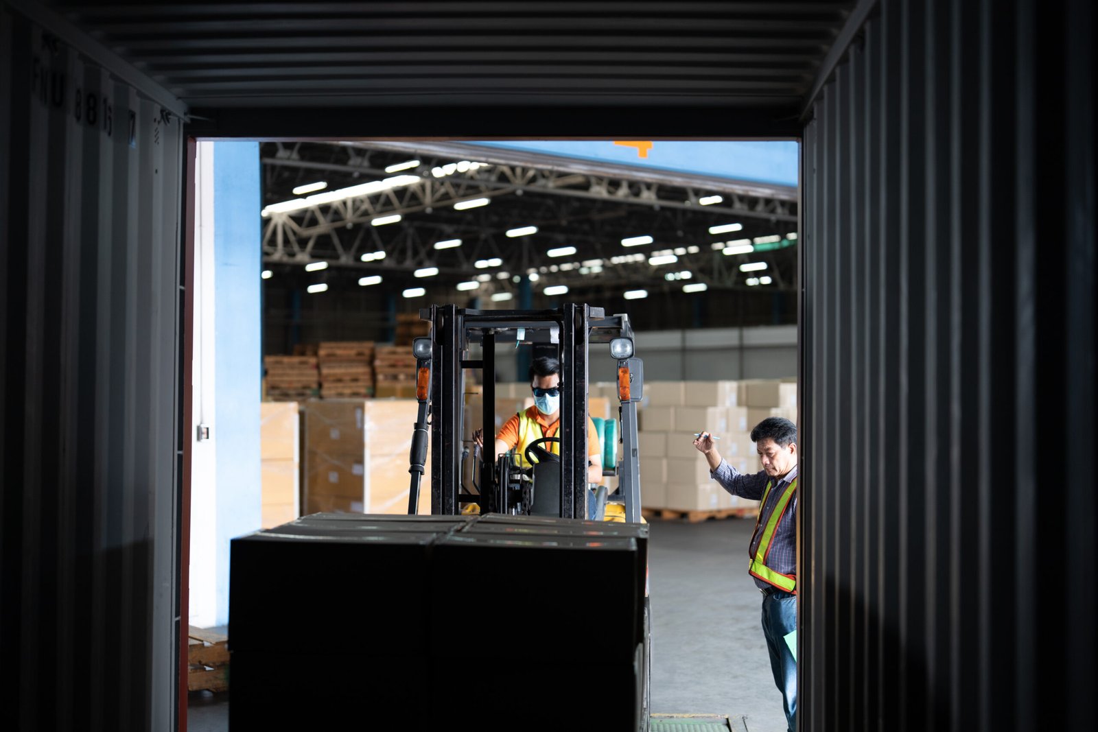 Forklift loading FCL container of PANOAR custom tactical belts for global delivery.