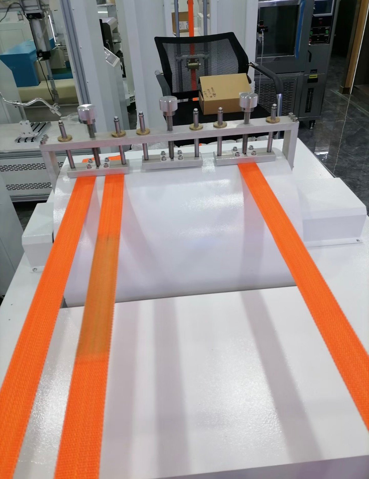 Quality control technician performing tensile tests on tactical gear hardware
