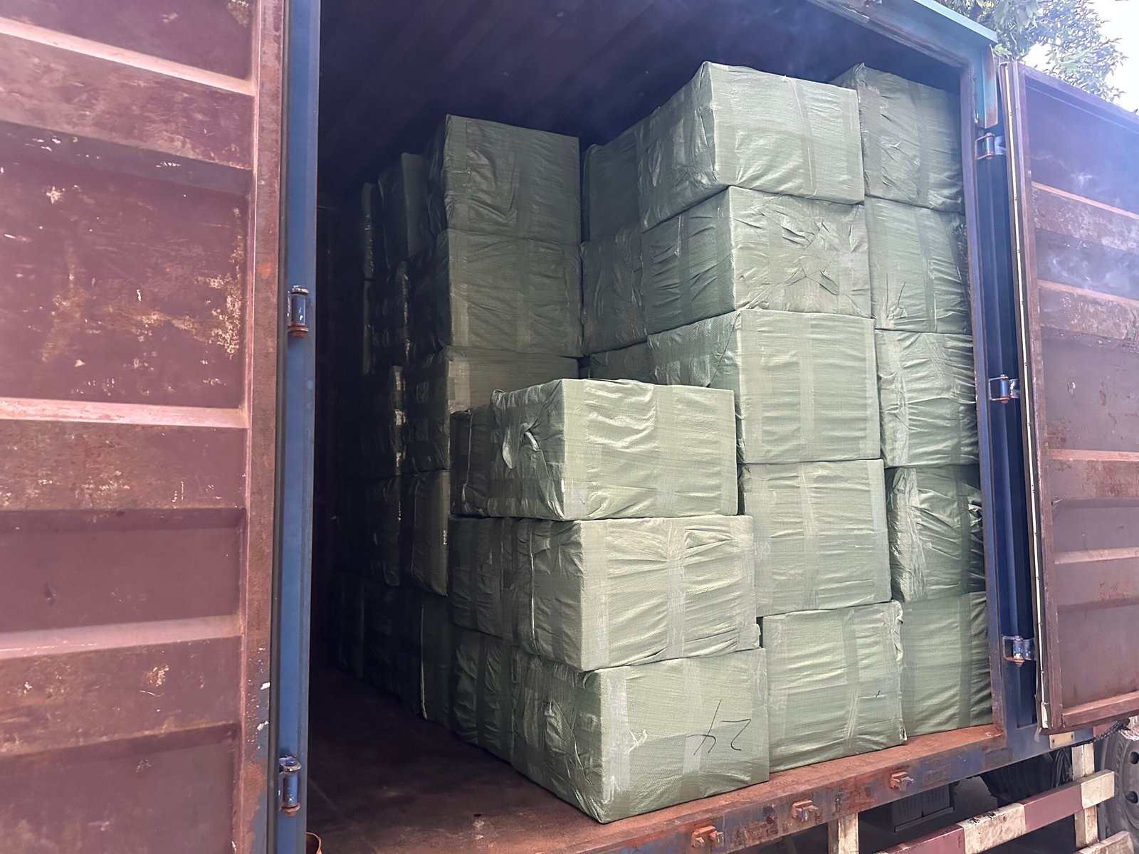 Bulk tactical gear cartons loaded in container for shipment