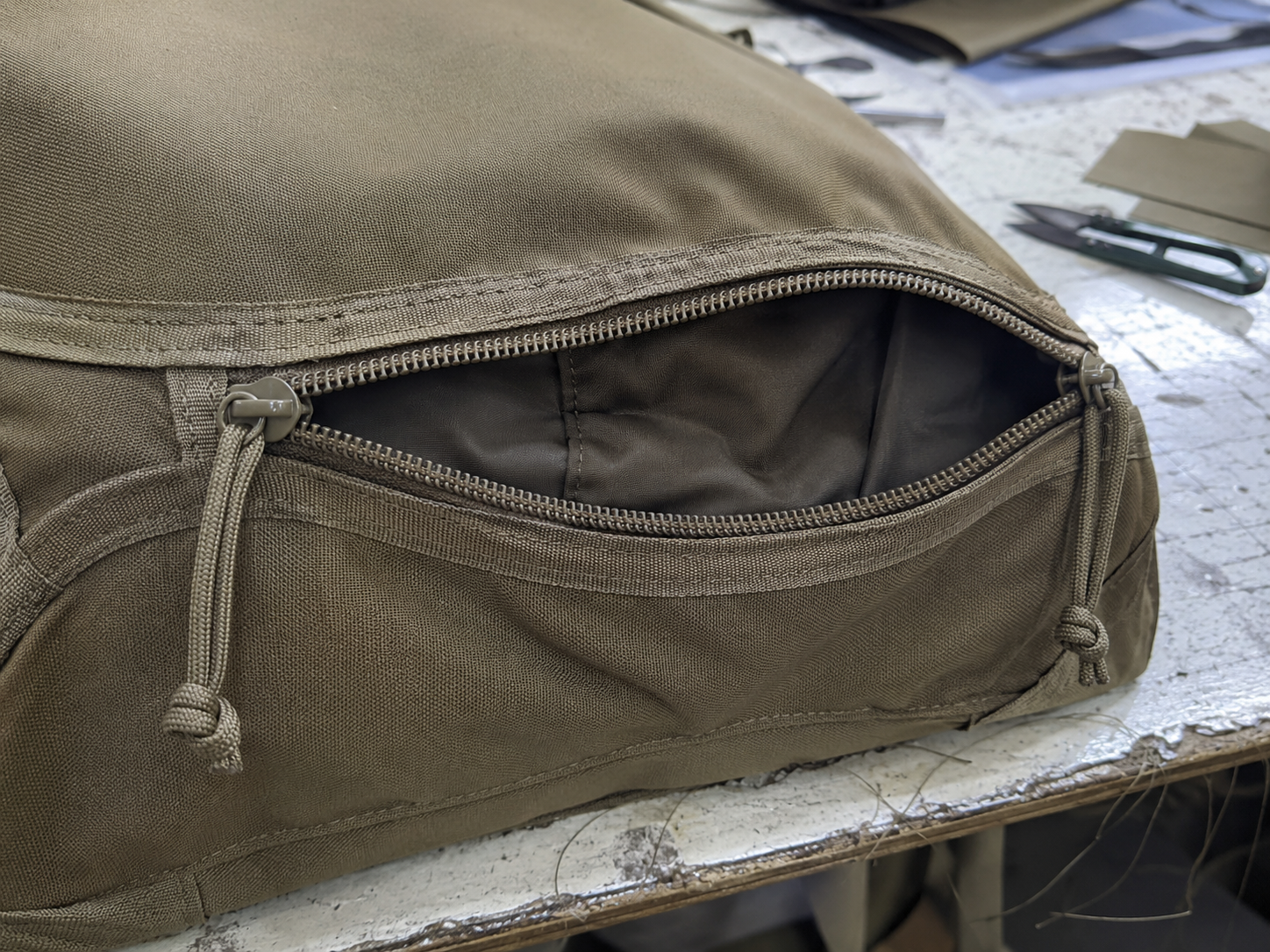 Close view of a tactical bag zipper opening and seam construction
