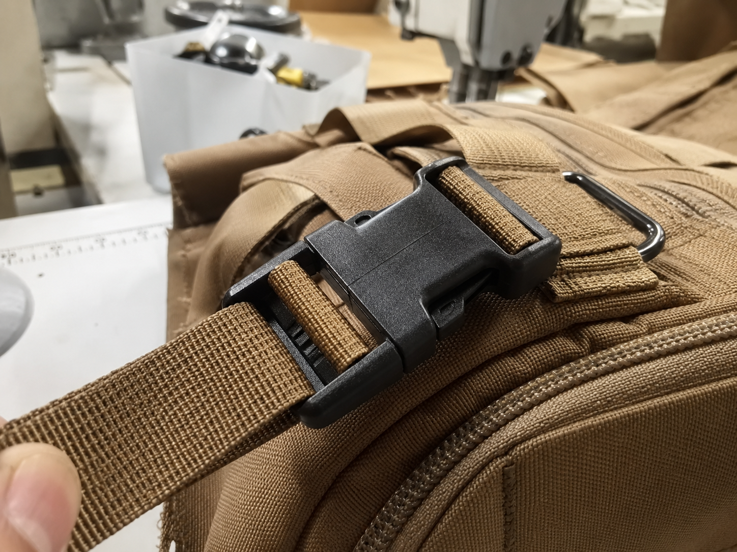 Close view of a buckle connected to tactical webbing