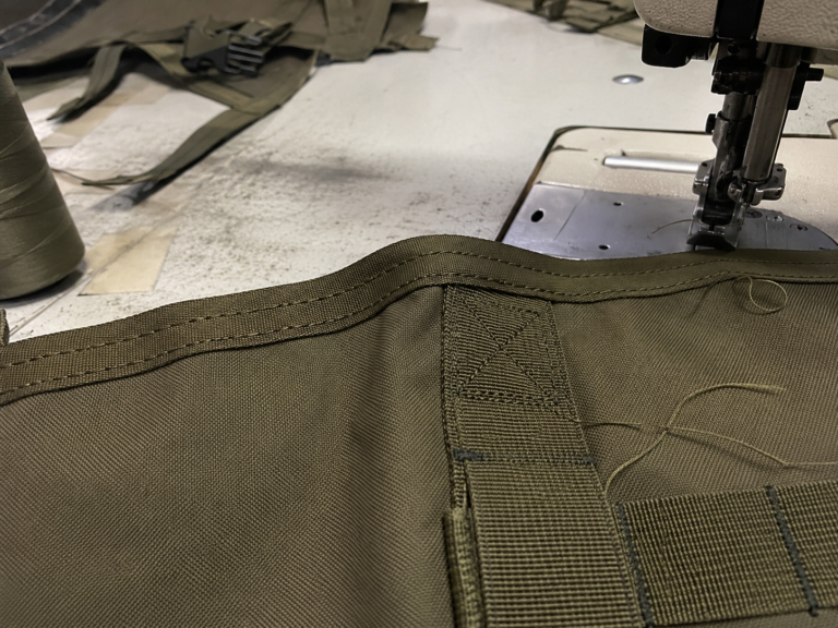 Close view of edge binding and reinforcement stitching on tactical gear
