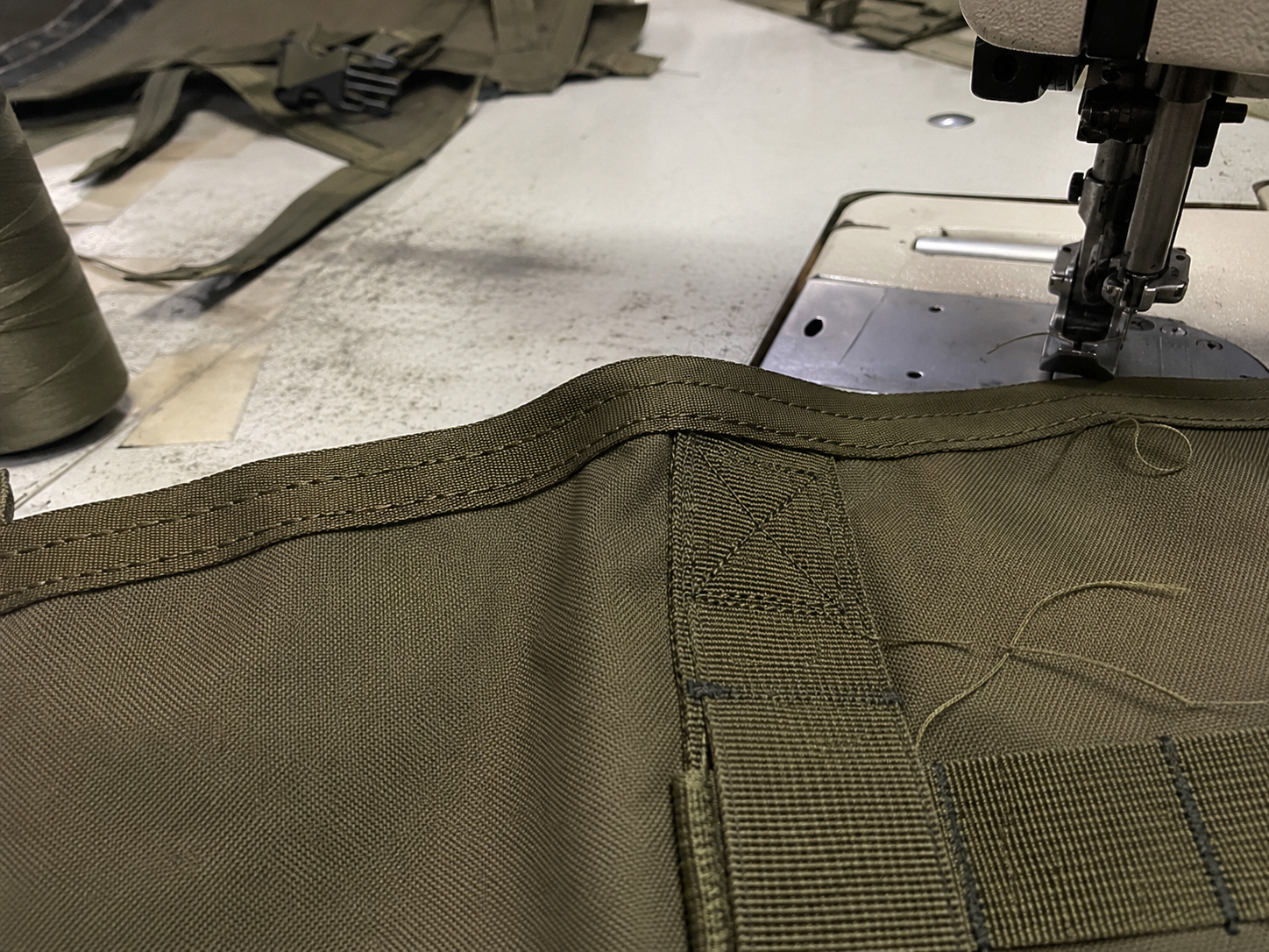 Close view of edge binding and reinforcement stitching on tactical gear