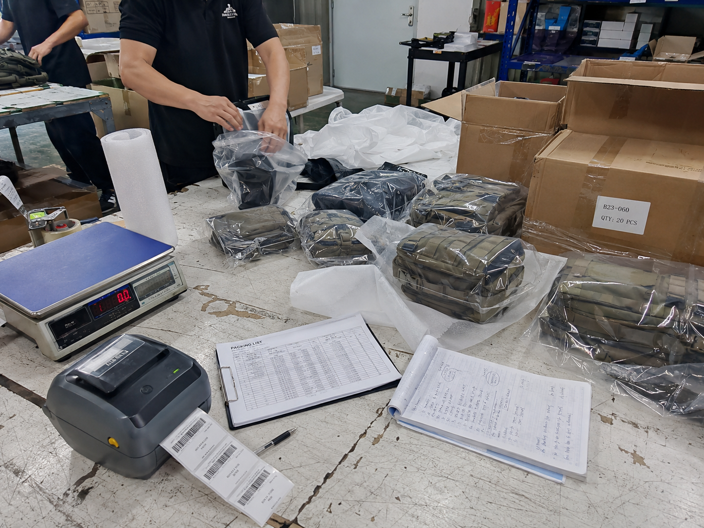 Tactical gear samples being checked and packed at a worktable
