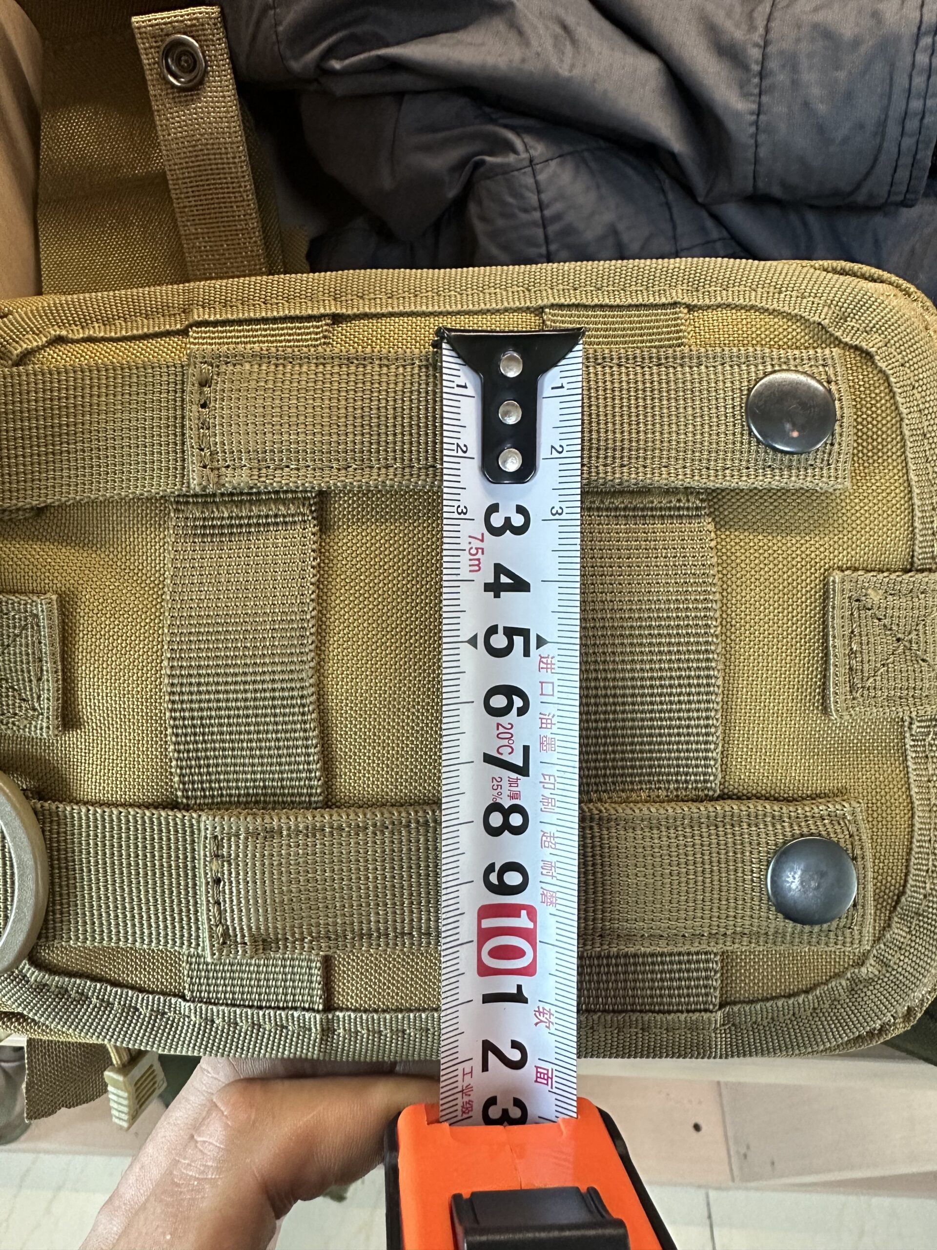 Tape measure checking the height of a coyote MOLLE pouch