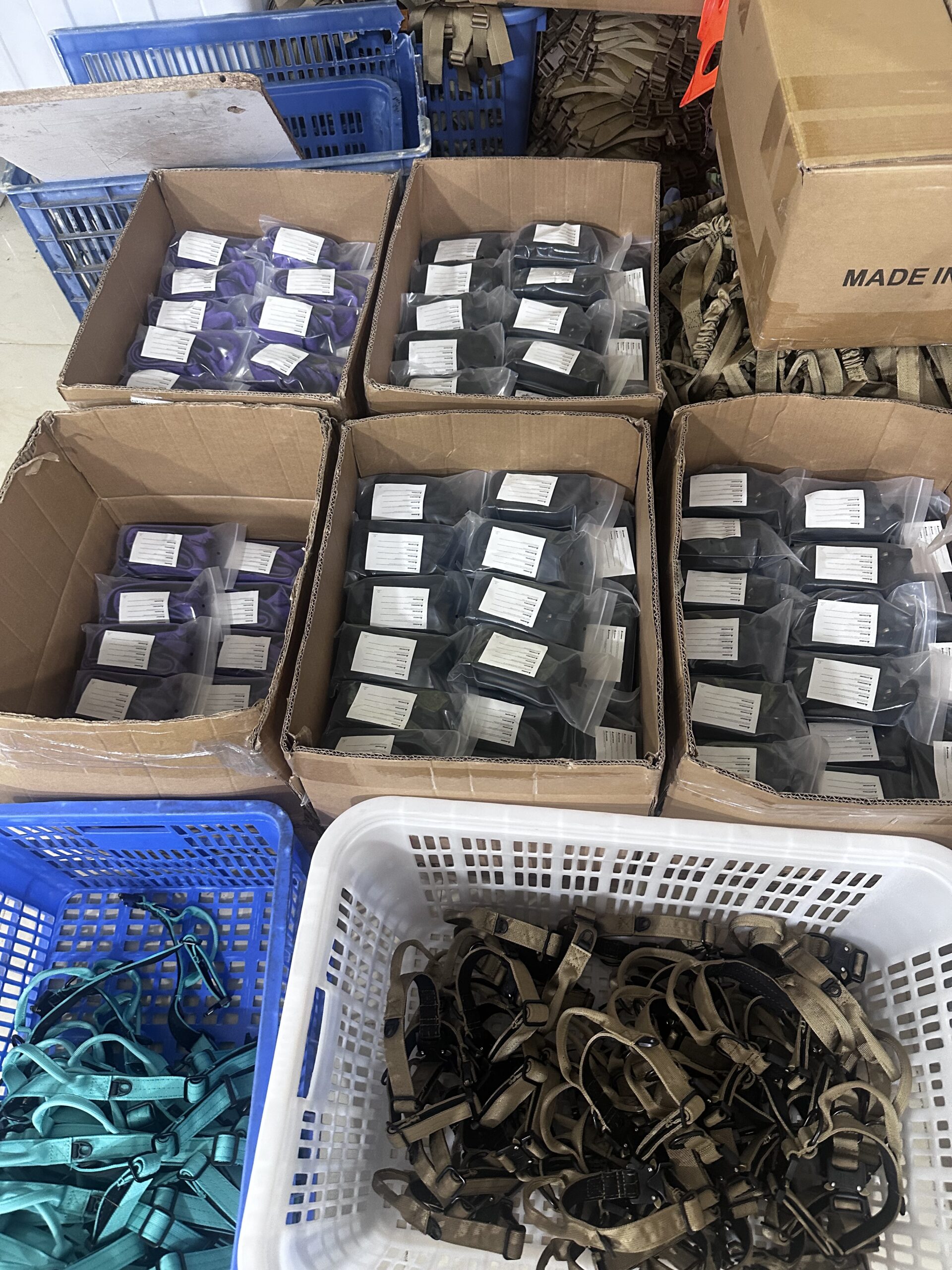 Finished tactical gear units individually bagged and labeled in cartons