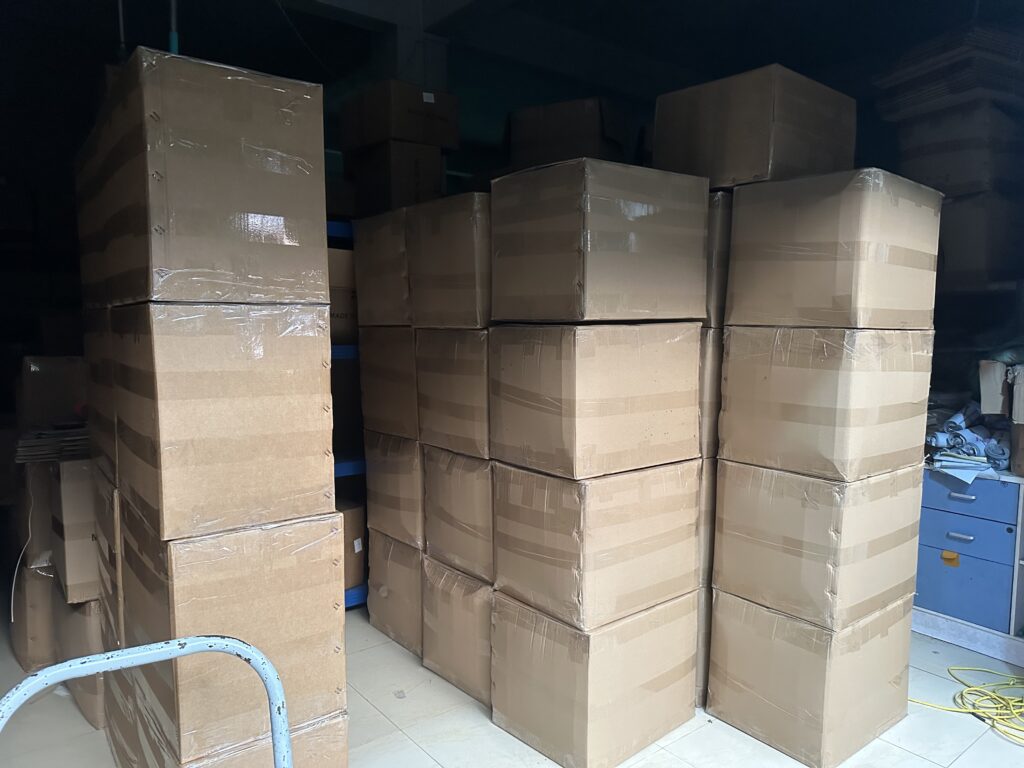 Packed tactical gear cartons stacked in PANOAR factory warehouse ready for shipment