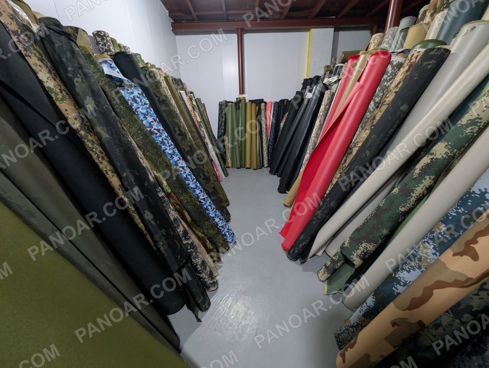 Camouflage rolls standing against a wall
