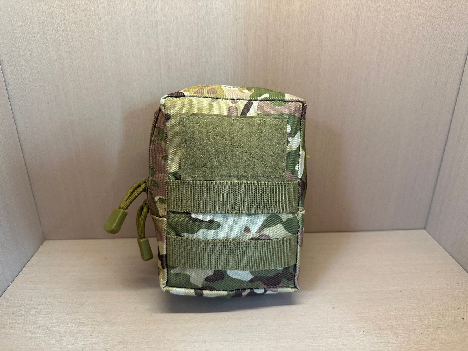 Camouflage IFAK pouch front reference with hook-and-loop panel, MOLLE webbing, and zipper pullers