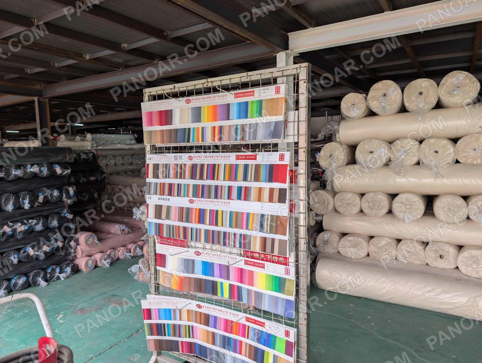 Color swatch board beside fabric rolls