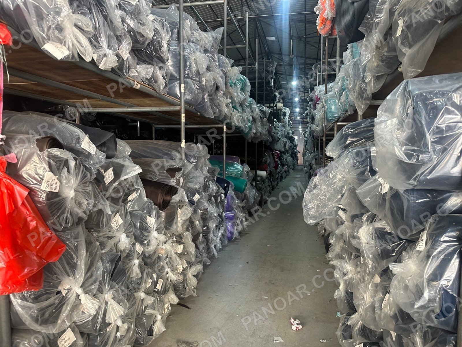 Wrapped rolls lining a warehouse aisle