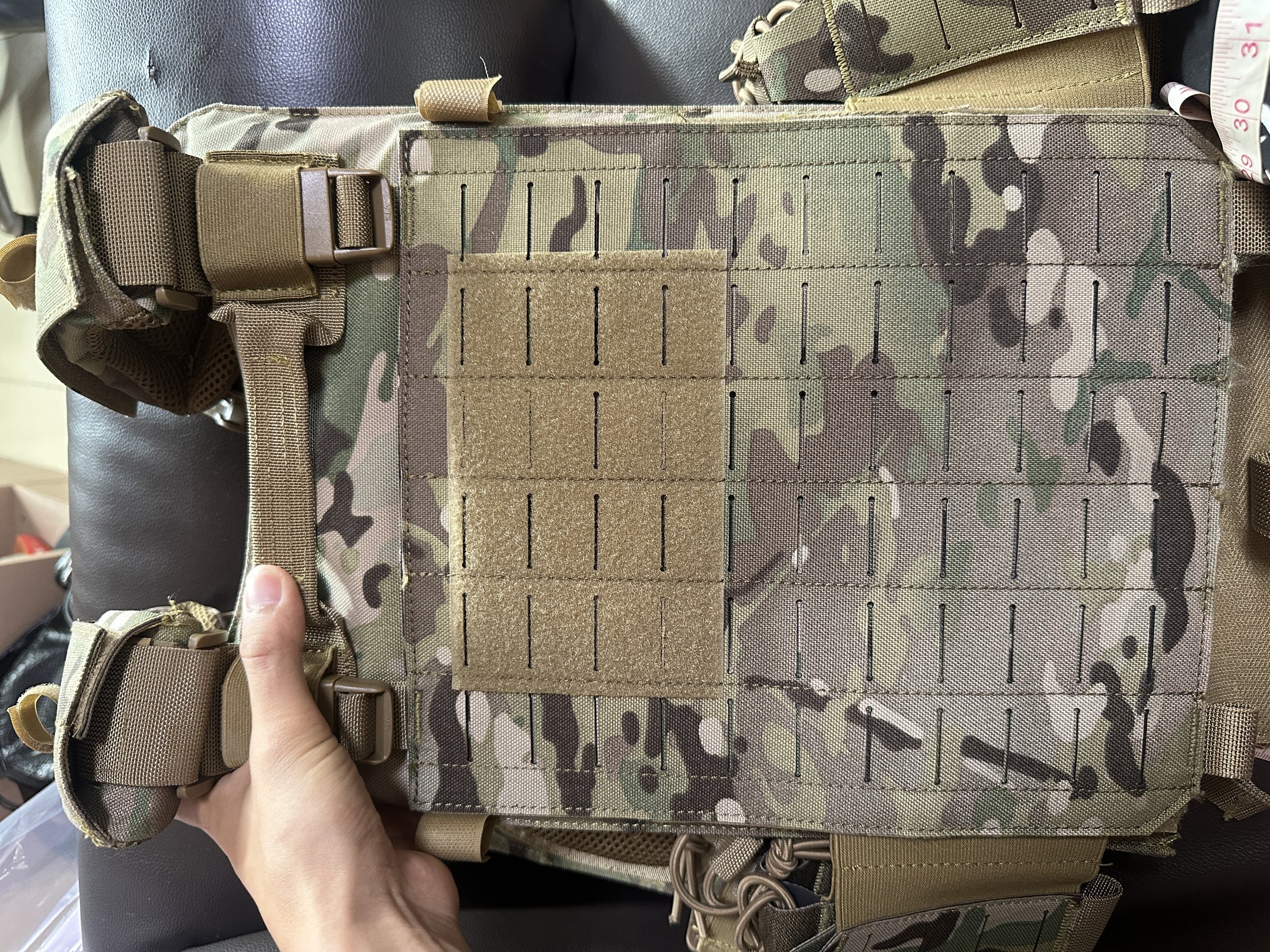 Plate carrier front panel with hook-and-loop field, laser-cut MOLLE slots and side buckles