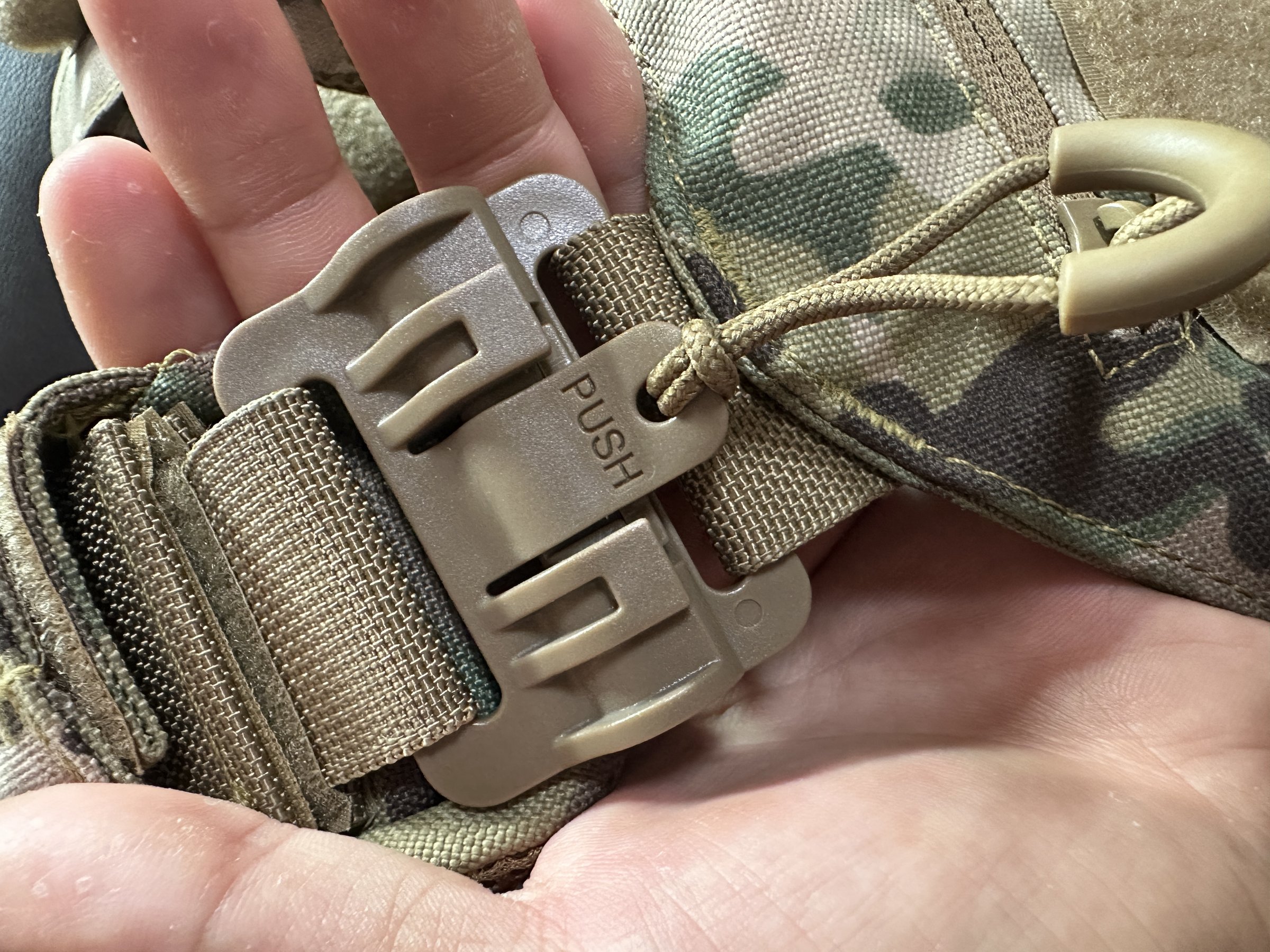 Side-release buckle, webbing and cord loop on a plate carrier
