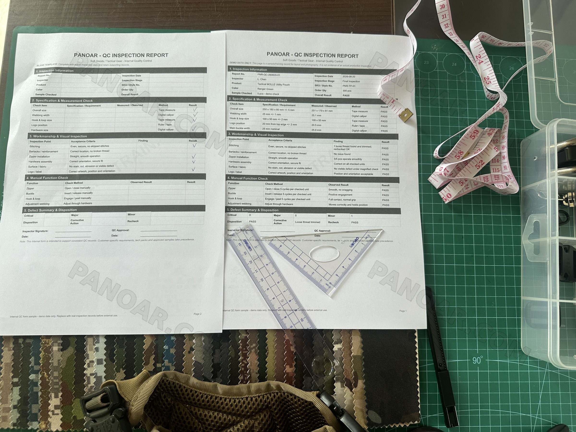 PANOAR QC inspection report sheets with a triangle ruler, tape measure and camouflage fabric on a cutting mat