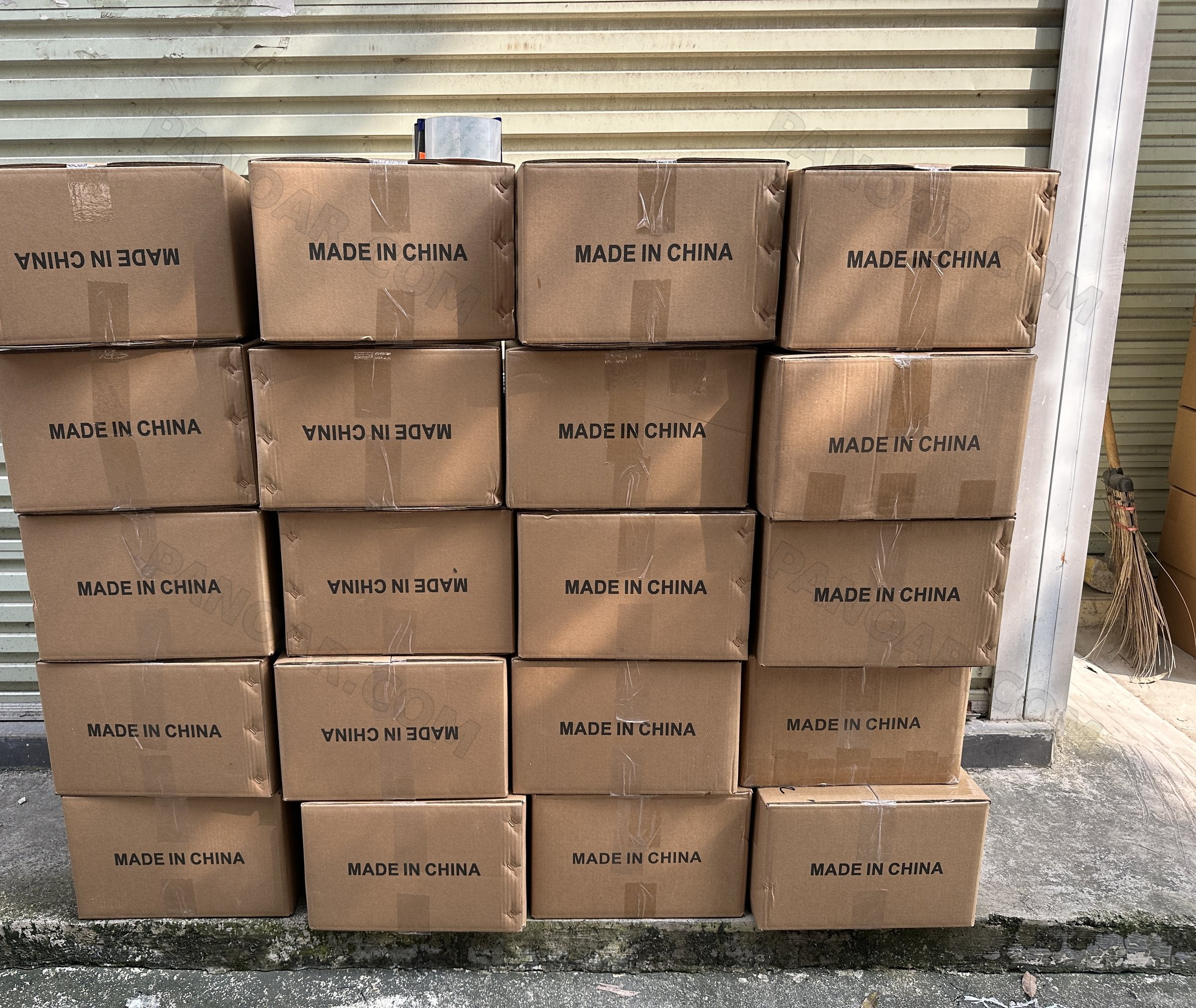 Export cartons printed Made in China, stacked in front of a roller door