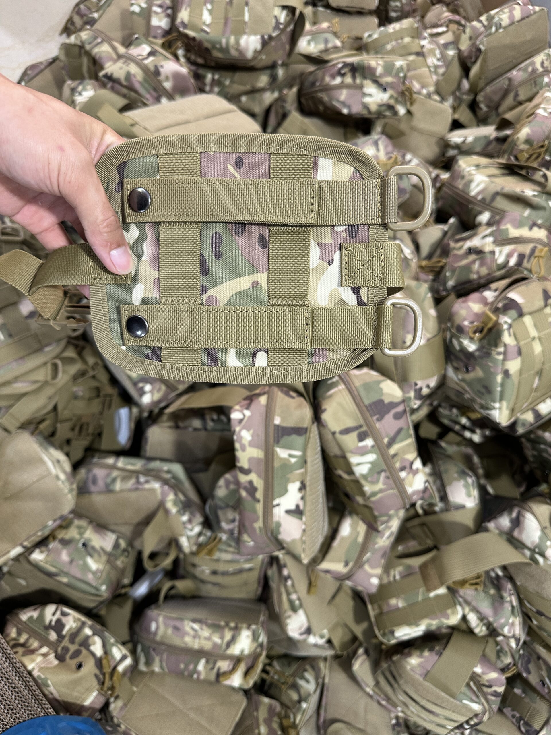 Box-X stitching on a webbing loop on the back of a camouflage pouch