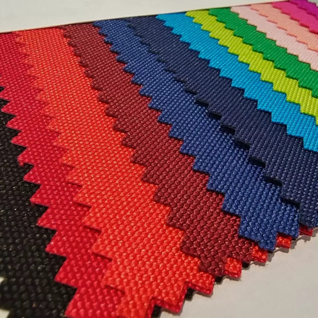 Fan of textured material swatches in red, blue, green and other colors.