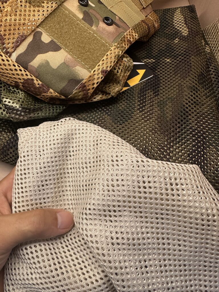 Light and dark mesh samples beside a camouflage dump pouch