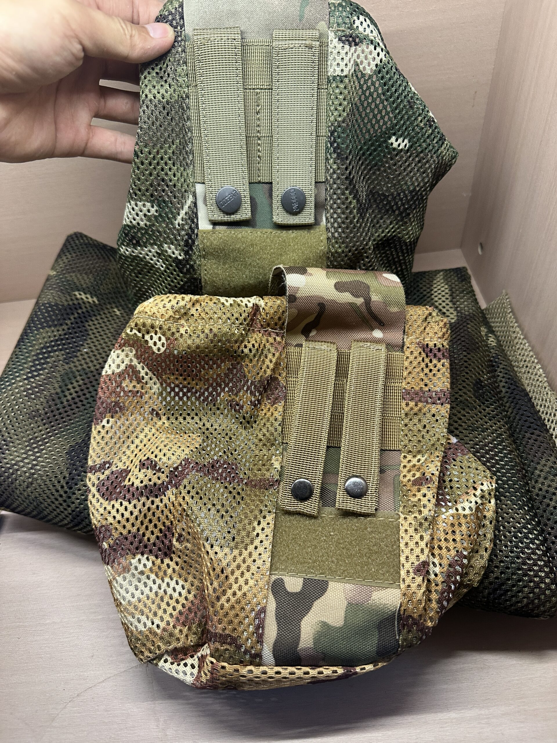 Two camouflage mesh dump pouch samples with rear webbing and snap-fastened straps.