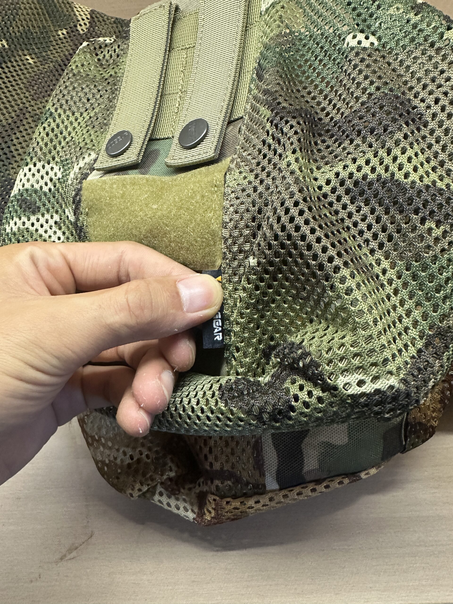 Woven label position on a camouflage mesh dump pouch sample.